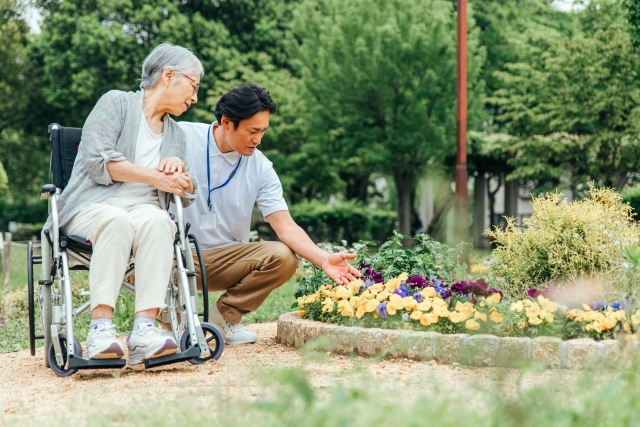 A caregiver walking alongside a senior client on a community outing